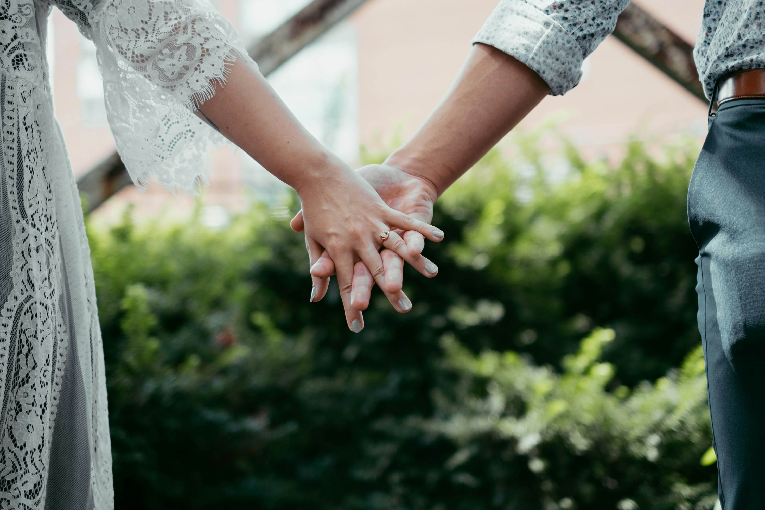 Couple intertwining hands