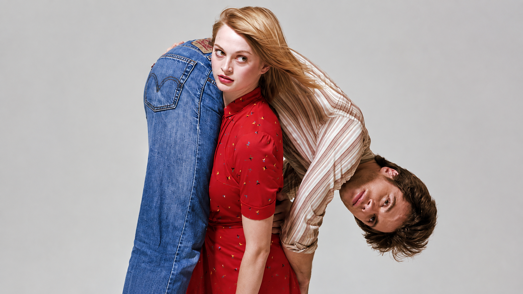 Woman carrying a man over his shoulders. 